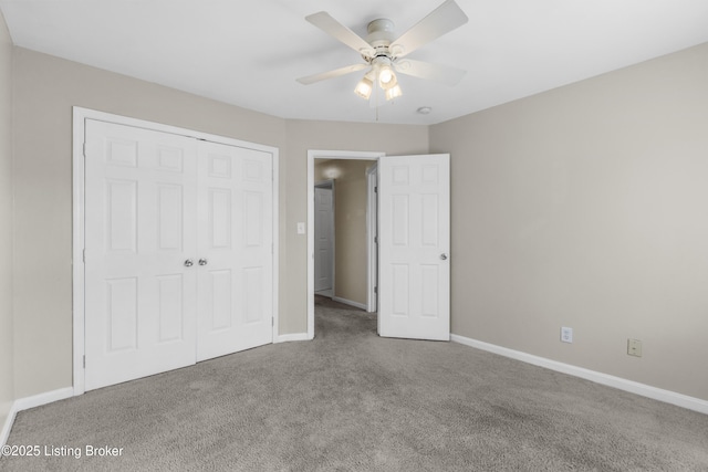 unfurnished bedroom with a closet, carpet, and baseboards