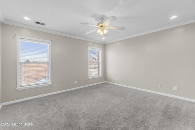 unfurnished room with ornamental molding, visible vents, ceiling fan, and baseboards