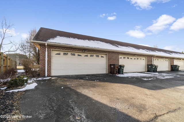 view of front of home with a garage and brick siding