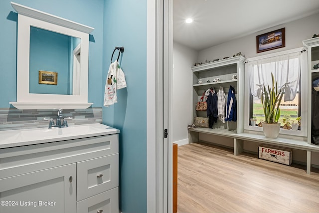 bathroom featuring backsplash, wood finished floors, and vanity