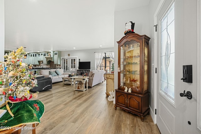 living room with a wealth of natural light, light wood-style flooring, and recessed lighting