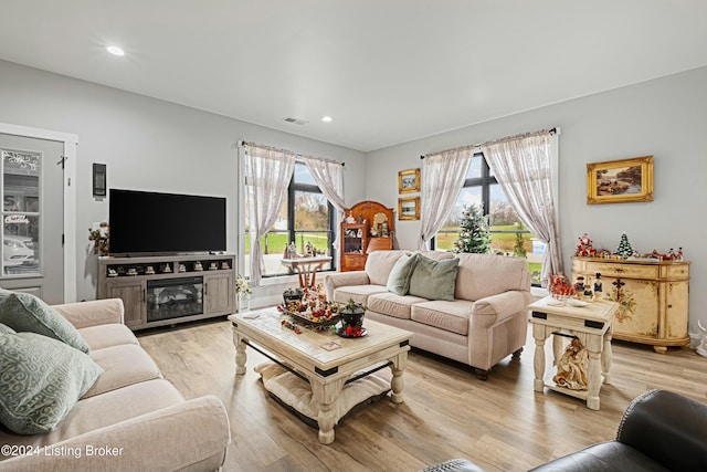 living room featuring light wood-style floors, recessed lighting, and visible vents