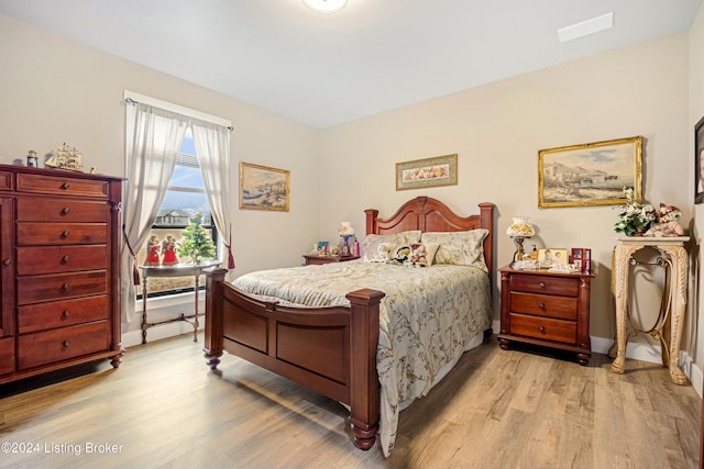 bedroom featuring light wood-type flooring and visible vents