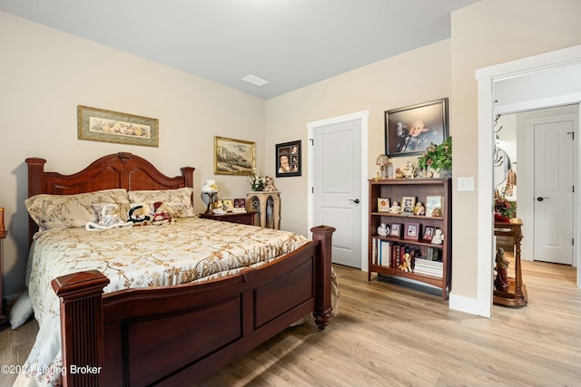 bedroom featuring light wood finished floors and visible vents