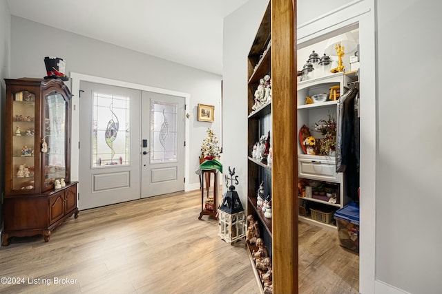 foyer featuring light wood-type flooring and french doors