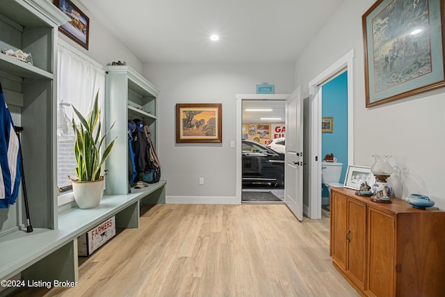 mudroom with baseboards, recessed lighting, and light wood-style floors