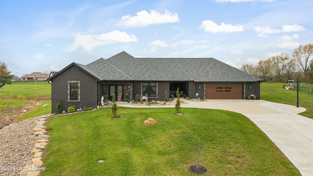 view of front facade featuring a garage, roof with shingles, driveway, and a front lawn