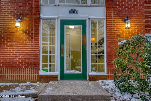 view of snow covered property entrance