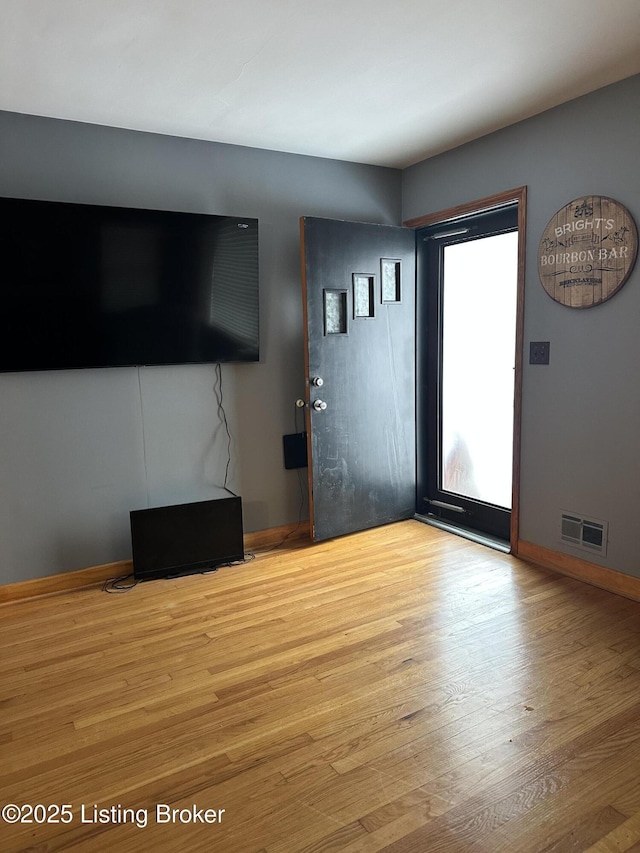 unfurnished living room featuring light hardwood / wood-style floors