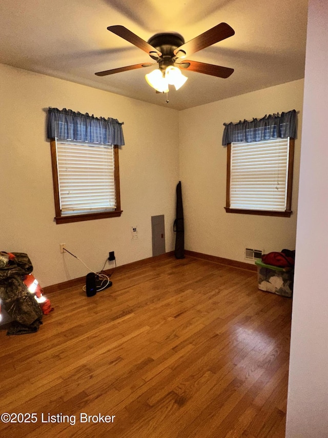 spare room featuring hardwood / wood-style flooring and ceiling fan