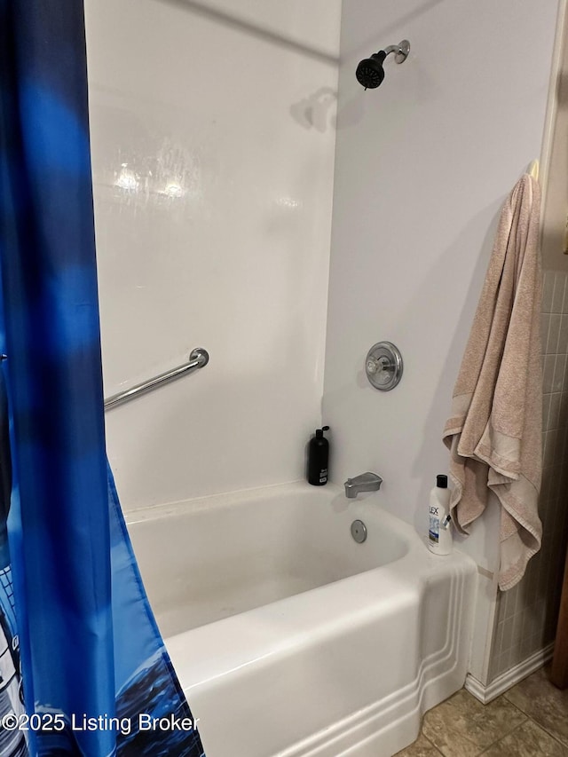 bathroom with shower / tub combo and tile patterned flooring