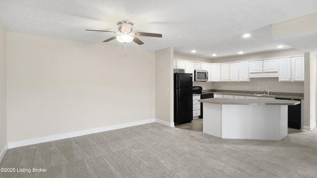 kitchen with black appliances, light carpet, a center island, sink, and white cabinetry