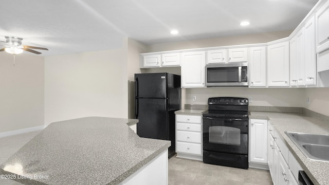 kitchen featuring ceiling fan, white cabinetry, sink, and black appliances