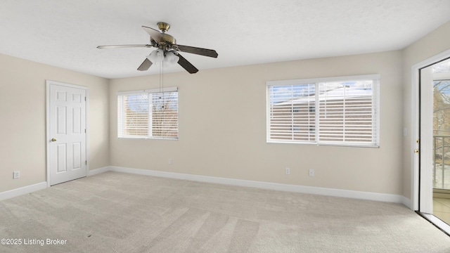 interior space featuring plenty of natural light, a textured ceiling, and light colored carpet