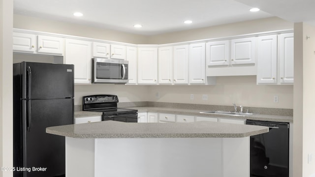 kitchen featuring white cabinets, sink, black appliances, and a kitchen island