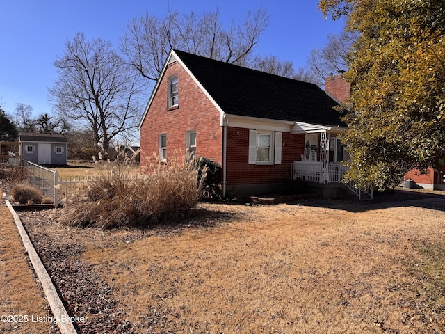 view of side of property with a storage unit