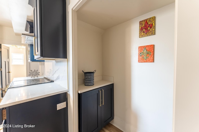 kitchen with a peninsula, range, and light countertops