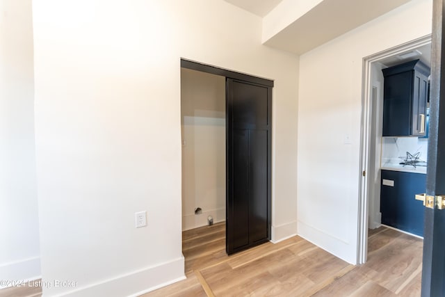 unfurnished bedroom with baseboards and light wood finished floors