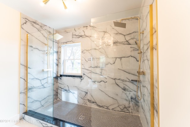 bathroom with a marble finish shower