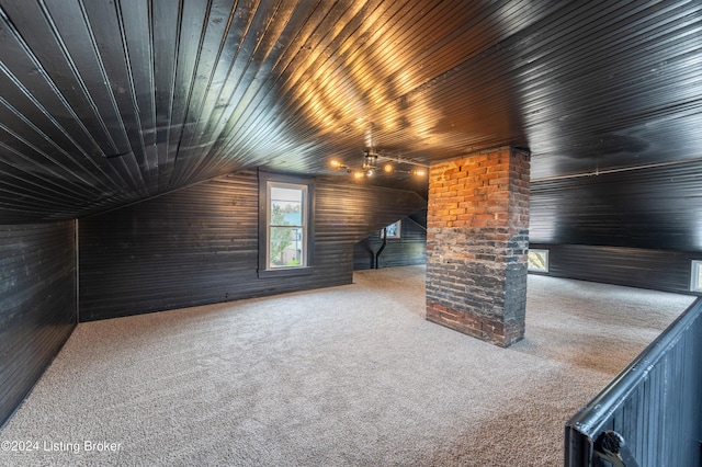 additional living space with lofted ceiling, wooden ceiling, and carpet