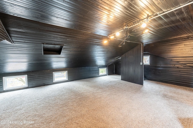 bonus room featuring vaulted ceiling, wood walls, plenty of natural light, and wood ceiling