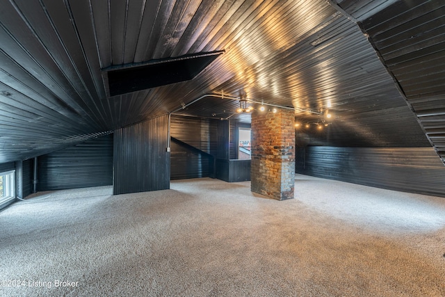 bonus room featuring carpet, wood ceiling, vaulted ceiling, and wooden walls