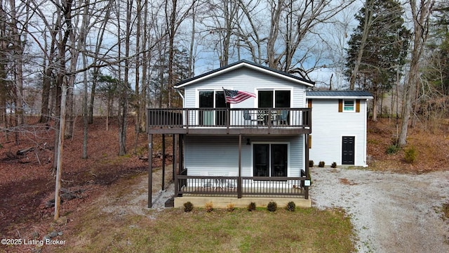 view of front facade featuring a deck, metal roof, and a standing seam roof