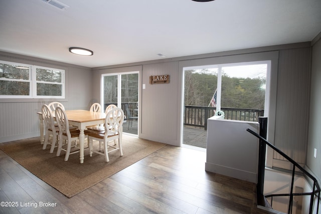 dining room featuring wood-type flooring and visible vents