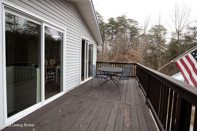 wooden terrace with outdoor dining area