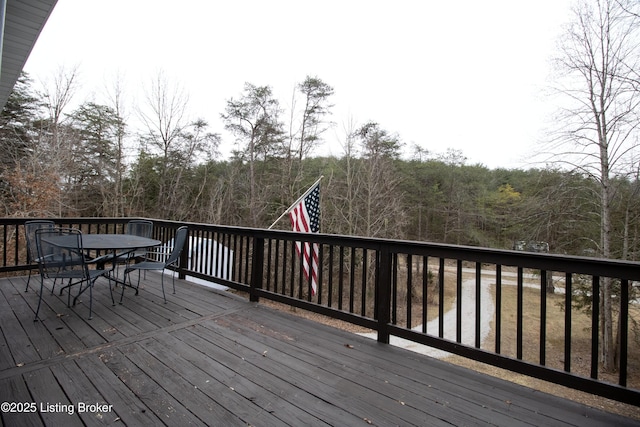 wooden terrace with outdoor dining space