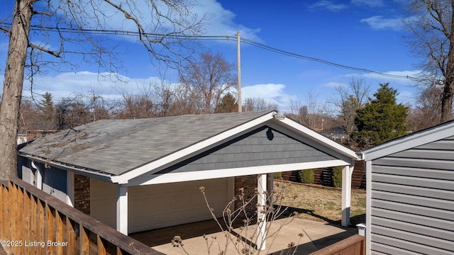 view of side of property with roof with shingles