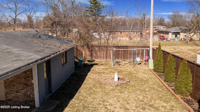 view of yard featuring a fenced backyard and a residential view