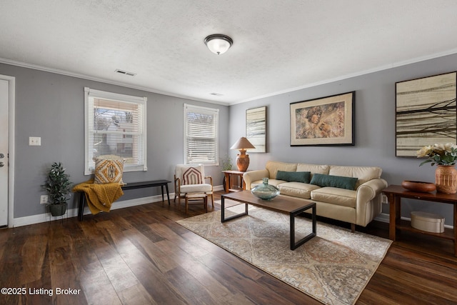 living room with visible vents, baseboards, hardwood / wood-style floors, crown molding, and a textured ceiling