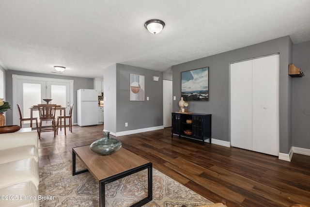 living room featuring baseboards and wood finished floors