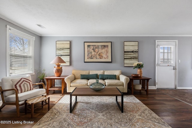 living room featuring dark wood-style floors, visible vents, crown molding, and baseboards