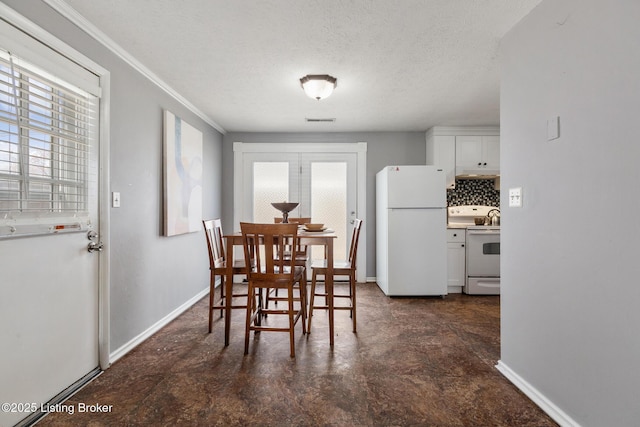 dining space with plenty of natural light, baseboards, and a textured ceiling