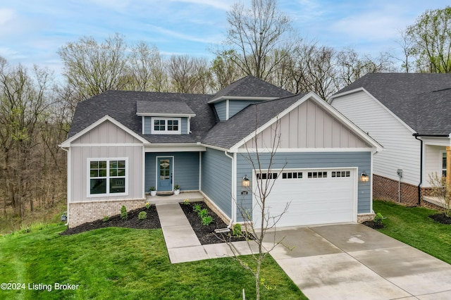 view of front of house with an attached garage, a front yard, board and batten siding, a shingled roof, and concrete driveway