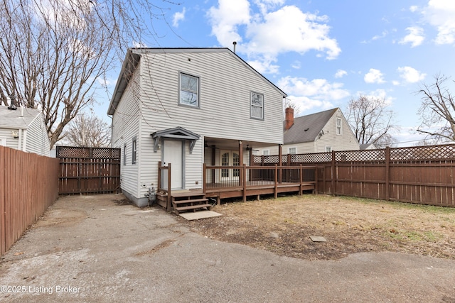 back of property featuring a fenced backyard and a wooden deck