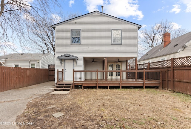 back of property featuring a fenced backyard, ceiling fan, and a deck