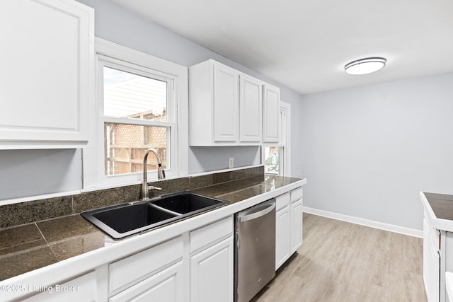 kitchen featuring tile countertops, a sink, white cabinets, stainless steel dishwasher, and light wood-type flooring