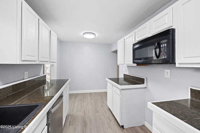 kitchen featuring black microwave, dishwasher, tile counters, and white cabinets