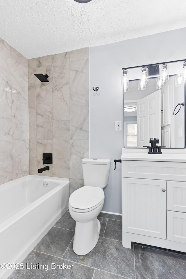 bathroom featuring a textured ceiling, shower / bathing tub combination, toilet, and vanity