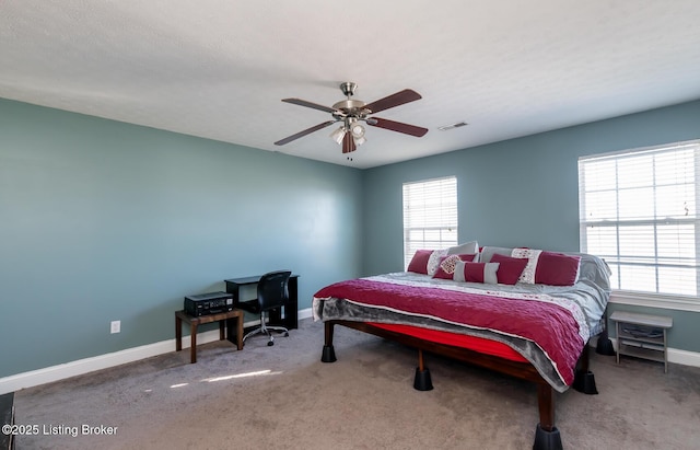 bedroom with a ceiling fan, carpet, visible vents, and baseboards