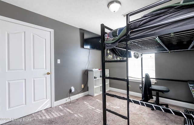 unfurnished bedroom featuring baseboards and carpet flooring