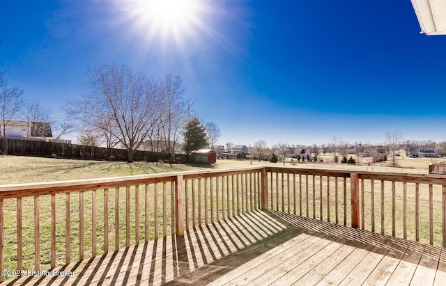 wooden deck with a yard and fence