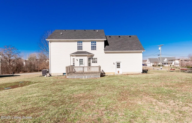 back of house featuring central AC, a yard, a deck, and roof with shingles