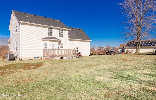 back of property with roof with shingles, a yard, a deck, and central AC unit