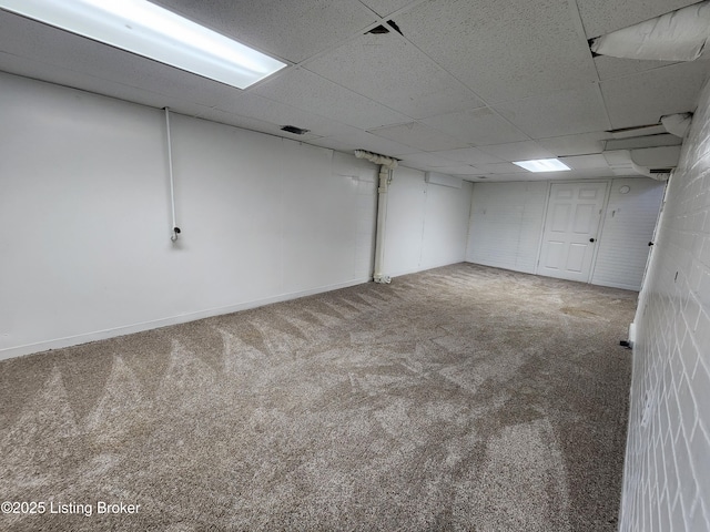 finished basement featuring carpet and a drop ceiling