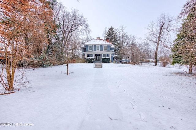 view of front of house with covered porch and a chimney