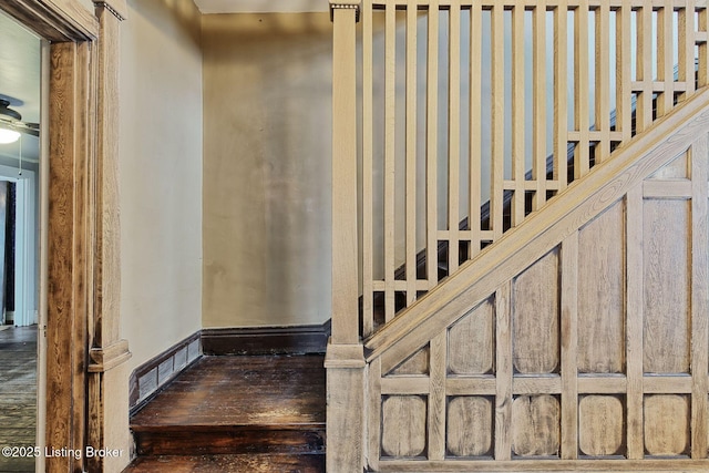 stairs with wood finished floors and baseboards